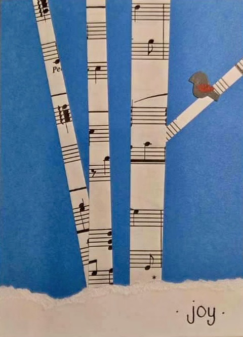 Stylized trees made of sheet music on a blue background, with a small bird on a branch. The word "joy" is written at the bottom, conveying a serene mood.
